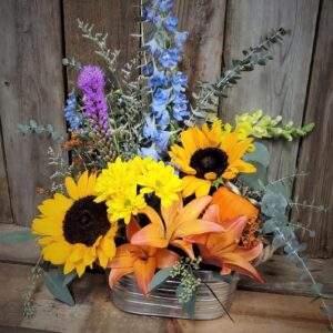 Stewart-Baxter-Funerals- Summer fall mix of flowers in a basket